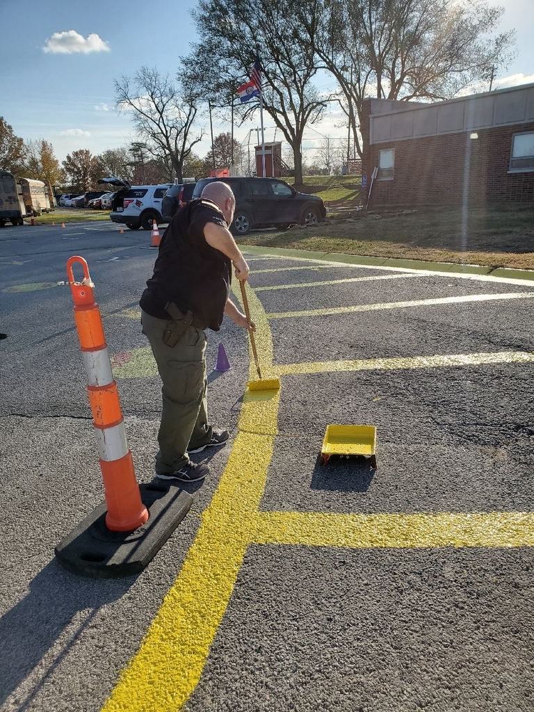 Deputy Little painting parking lot lines 